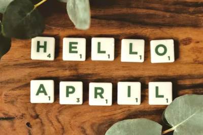 Scrabble pieces spelling out Hello April