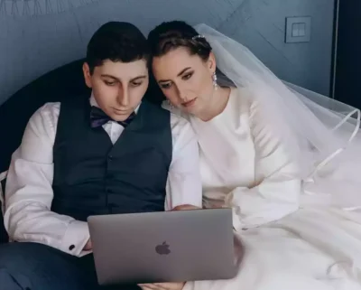 Bride and groom with a laptop