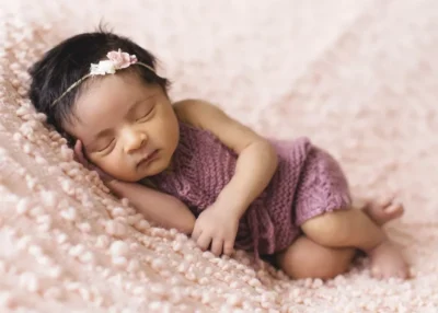 New born baby girl in a pink dress